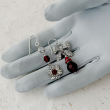 Load image into Gallery viewer, asymmetric earrings in red and silver displayed on a grey gloved hand