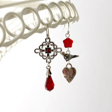 Load image into Gallery viewer, Silver and red asymmetric earrings hanging against a white background