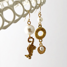 Load image into Gallery viewer, asymmetric gold earrings with pearl beads, seahorse and shell charms on a white background