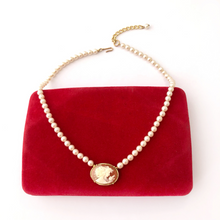 Load image into Gallery viewer, pearl and cameo necklace displayed on a vintage red velvet jewellery box
