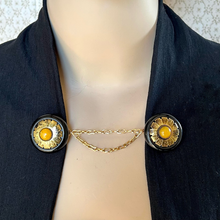 Load image into Gallery viewer, Mannequin wearing a black jacket held with a gold and black cloak clasp or sweater clip