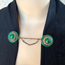 Load image into Gallery viewer, Mannequin wearing a black jacket held with a green and gold cloak clasp or sweater clip