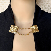 Load image into Gallery viewer, Gold chain cloak clasp or sweater clip with floral designs on a mannequin wearing a black jacket.
