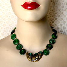 Load image into Gallery viewer, statement necklace in antique gold with emerald green buttons displayed on a mannequin