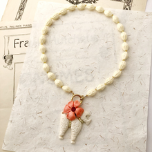 Load image into Gallery viewer, necklace of cream beads with poodle and coral coloured flower charms