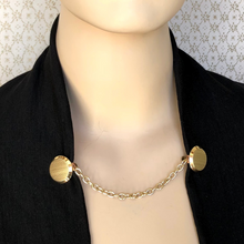 Load image into Gallery viewer, gold-tone sweater clip holding black jacket edges together