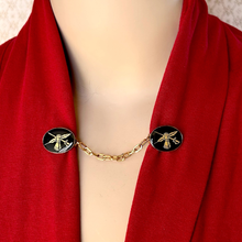 Load image into Gallery viewer, sweater clip or cloak clasp with heraldic theme on a red jacket