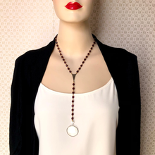 Load image into Gallery viewer, Mannequin wearing a black blazer and white top with a red beaded y-shaped necklace with a lens as a feature.
