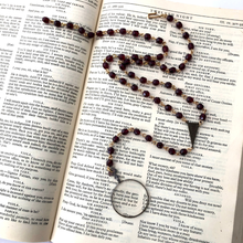 Load image into Gallery viewer, Y-shaped necklace on an open book