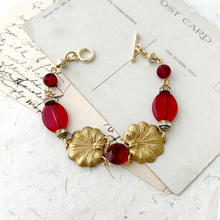 Load image into Gallery viewer, bracelet of red and old vintage components displayed on some vintage postcards