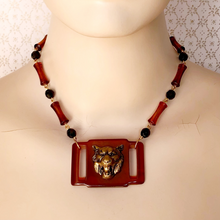 Load image into Gallery viewer, mannequin wearing a necklace created with a vintage plastic belt buckle embellished with roaring tiger's head and vintage black and faux tortoiseshell beads