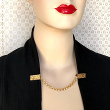 Load image into Gallery viewer, sweater clip holding black jacket edges