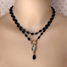 Load image into Gallery viewer, A reimagined vintage necklace with black beads and cameo set focal pendant wrapped twice around a mannequins neck