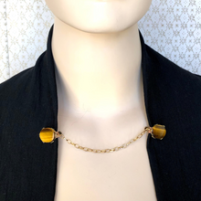 Load image into Gallery viewer, sweater clip with Tiger's eye gemstone on a black jacket