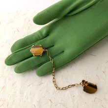 Load image into Gallery viewer, sweater clip with Tiger's eye gemstone on a green gloved hand