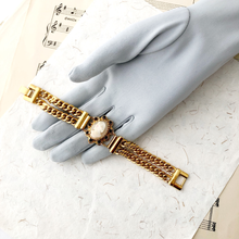 Load image into Gallery viewer, double strand chain bracelet with cameo focal displayed on a grey gloved hand