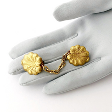 Load image into Gallery viewer, golden lily pad sweater clip displayed on a gloved hand