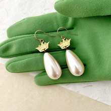Load image into Gallery viewer, Pearl earrings with gold crown accents on green gloves