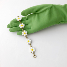 Load image into Gallery viewer, bracelet with vintage plastic daisies displayed on a gloved hand
