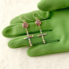 Load image into Gallery viewer, Earrings with cross design with multicolored rhinestones on a green gloved hand