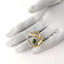 Load image into Gallery viewer, vintage gold circle brooch with three leaves and a jade stone displayed on a gloved hand