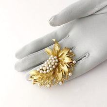 Load image into Gallery viewer, gold tone and pearl vintage Lisner brooch inspired by nature displayed on a gloved hand