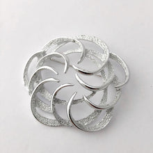 Load image into Gallery viewer, swirled silver coloured brooch on a white background