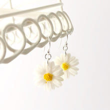 Load image into Gallery viewer, earrings made with vintage plastic daisies hanging from a white wire lace frame