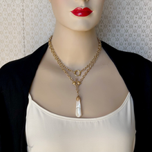 Load image into Gallery viewer, mannequin wearing a mother of pearl pendant on gold plated chain as a double stranded necklace
