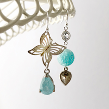 Load image into Gallery viewer, asymmetric earrings in aqua and silver tone with butterfly and heart charm
