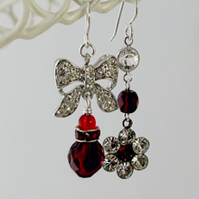 Load image into Gallery viewer, asymmetric earrings in red and silver hanging from a white wire frame
