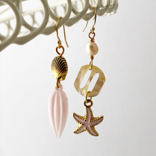 Load image into Gallery viewer, asymmetric earrings with shell, starfish, Mother of pearl buckle, pearl and pink leaf drop hanging against a white background
