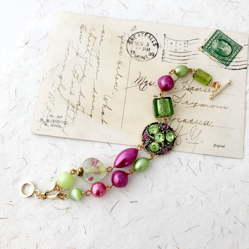 pink and green beaded bracelet on an old postcard