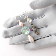 Load image into Gallery viewer, asymmetric earrings in pink and silver on a gloved hand
