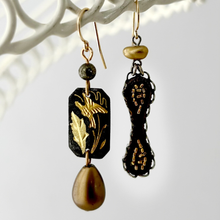 Load image into Gallery viewer, Handmade earrings made with vintage elements in bronze and charcoal tones hanging from a white wire frame
