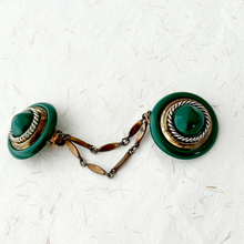 Load image into Gallery viewer, green and gold cloak clasp or sweater clip on handmade paper background
