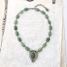 Load image into Gallery viewer, art deco rhinestone set pendant with green faceted aventurine bead chain displayed on sheets of paper
