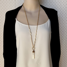 Load image into Gallery viewer, necklace with mother of pearl pendant and beads with gold chain displayed on mannequin
