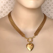 Load image into Gallery viewer, necklace of brick chain with front opening clasp and large brass heart locket set with a Swarovski flat back rhinestone on a mannequin
