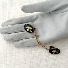 Load image into Gallery viewer, sweater clip or cloak clasp with heraldic theme displayed on a grey gloved hand
