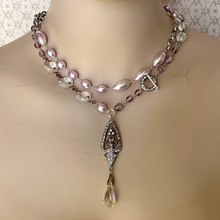 Load image into Gallery viewer, A reimagined vintage necklace with pink pearls, chandelier crystals,rhinestone filigree pendant and clear crystal drop wrapped twice around a mannequins neck
