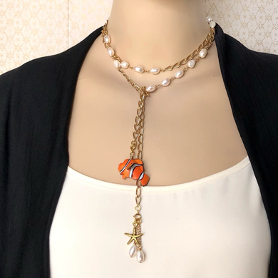 wrap style necklace with freshwater pearls, starfish and nemo toy charms on a mannequin