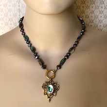 Load image into Gallery viewer, Necklace with paua shell and freshwater pearl beads and a decorative pendant on a mannequin.
