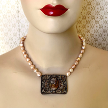 Load image into Gallery viewer, Mannequin wearing a freshwater pearl necklace with metal filigree cameo focal
