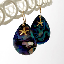 Load image into Gallery viewer, paua shell and starfish charm earrings hanging against a white background
