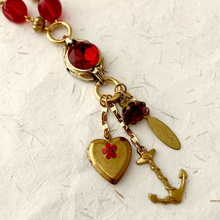 Load image into Gallery viewer, close up of chatelaine style tassel made with vintage charms on reimagined vintage necklace
