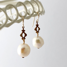 Load image into Gallery viewer, elegant pearl earrings with vintage connectors hanging from a white frame
