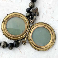 Load image into Gallery viewer, Brass locket with removable panels on a white textured background
