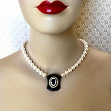 Load image into Gallery viewer, Mannequin wearing a pearl necklace with a vintage black and white cameo pendant against a patterned background
