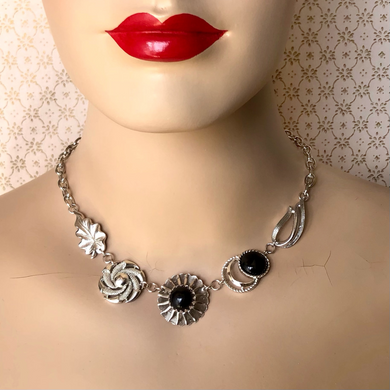 mannequin wearing a necklace made with repurposed vintage black and silver-toned earrings